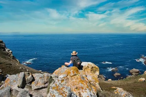 Someone sitting on a cliff in Spain