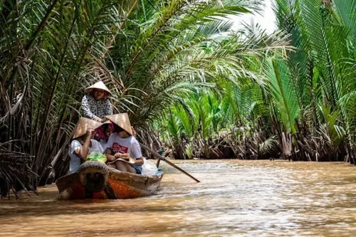 Vietnamese people on a boat on a local river